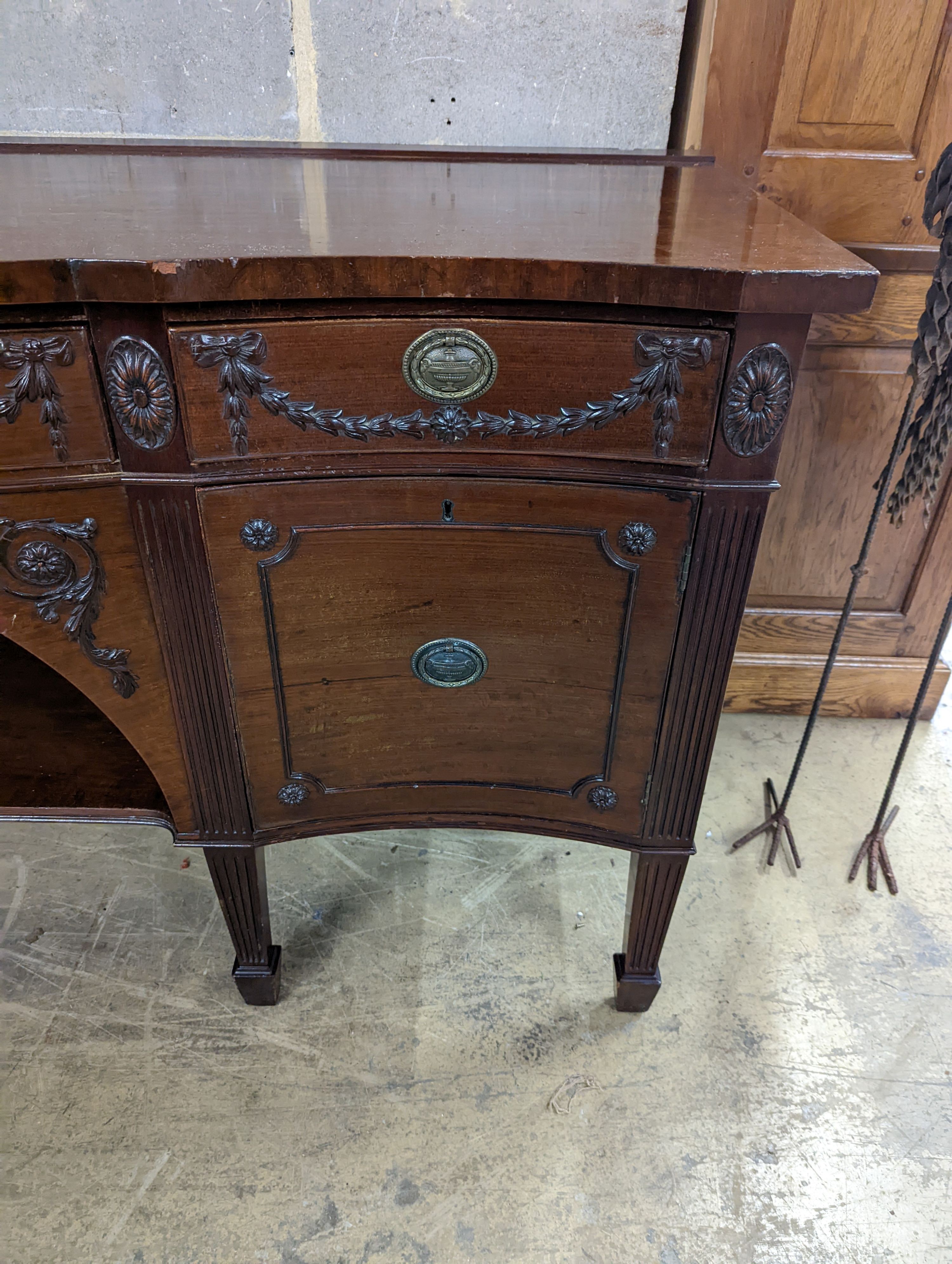 An early 20th century Adam design mahogany serpentine sideboard, length 214cm, depth 68cm, height 92cm